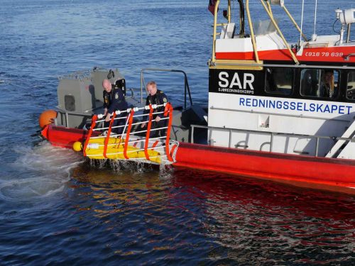 Dacon Rescue Dummy being recovered onboard from the water in a rescue net.